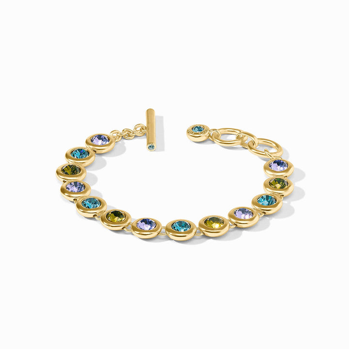 The Rainbow Tennis Bracelet | Blue Twilight: round bezel-set multicolored gems, 24K gold plate, toggle clasp, adjustable sizes.