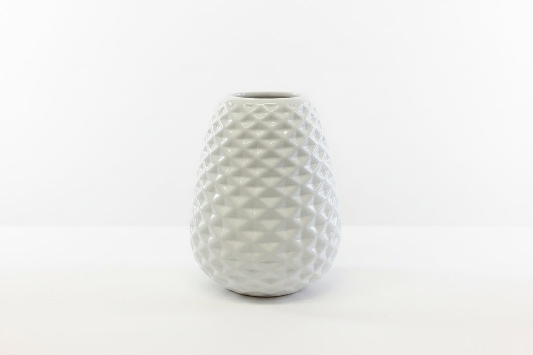 White ceramic vase with textured geometric diamond pattern; available in multiple sizes.