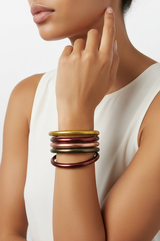 Set of five metallic bangles—four bronze, one gold—from The Autumn AWS Stack Bangles, available in sizes S, M, and L.