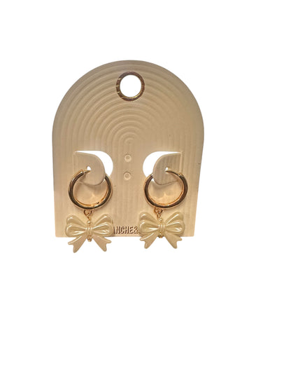 Gold thin huggie hoop earrings with cream-colored bows. Sizes available: small, medium, large.