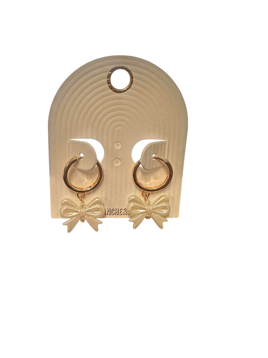 Gold thin huggie hoop earrings with cream-colored bows. Sizes available: small, medium, large.