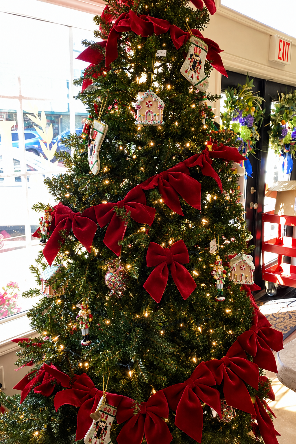 Christmas tree with Bow Banner, string lights, red bows, and nutcracker-themed ornaments.