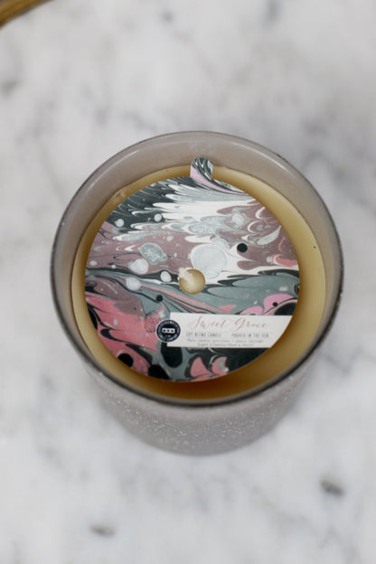 Sweet Grace Collection #045 candle in frosted glass with marbled pink, black, and white label. Soy-blend wax. Sizes: S, M, L.
