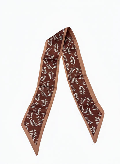 Narrow brown silk scarf necklace with beige and white leaf pattern, pointed ends, lighter brown border. Sizes: S, M, L.