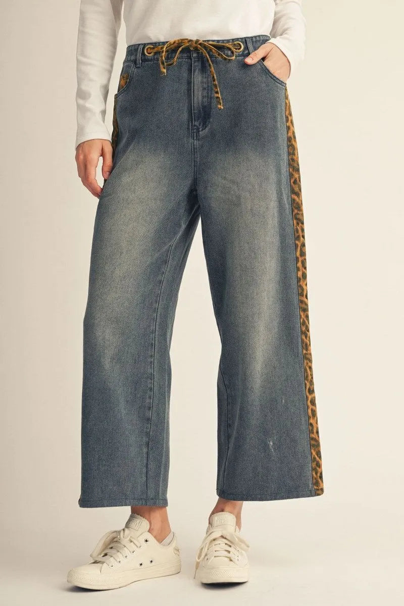 Cheetah Contrast Jeans: wide-leg, washed denim with a drawstring waist and leopard-print detail on the sides. Available in sizes XS–XL.
