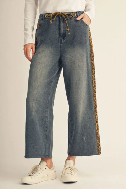 Cheetah Contrast Jeans: wide-leg, washed denim with a drawstring waist and leopard-print detail on the sides. Available in sizes XS–XL.