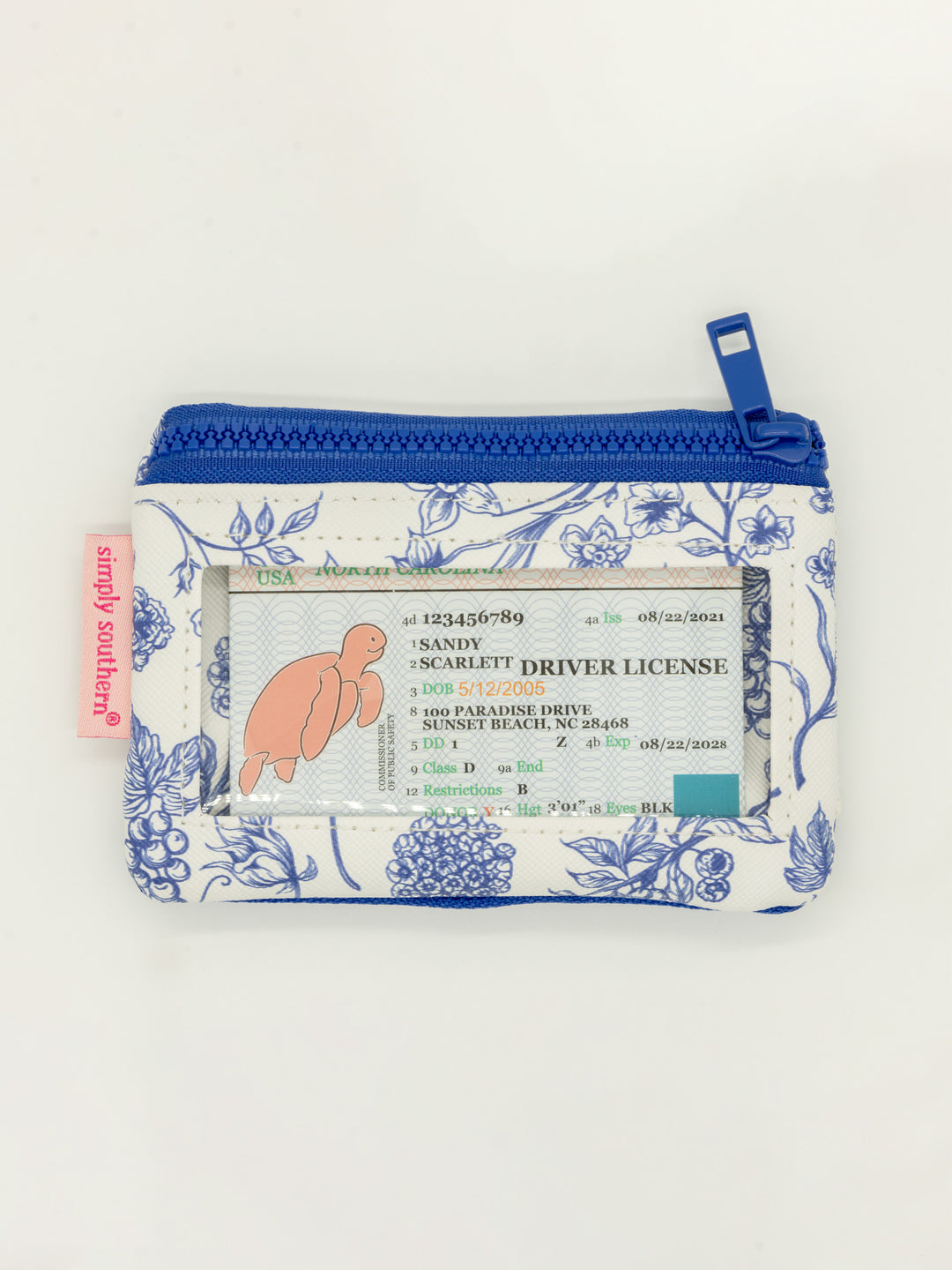 Small blue floral ID wallet with zippered pockets, clear window, blue zipper, pink tag, keyring. Sizes available.