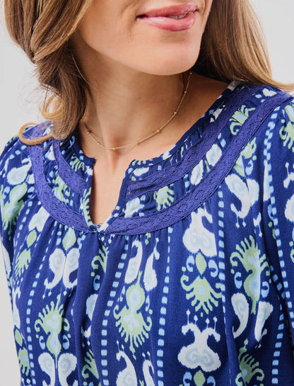 Janelle Top Ikat Stripe: blue blouse with green and white patterns, notched neckline. Available in sizes XS–XL.