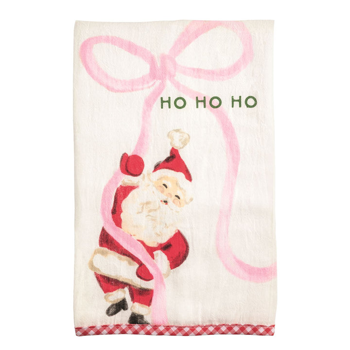 White Christmas hand towel with Santa Claus, pink ribbon, “HO HO HO” text, and red and white checkered hem.