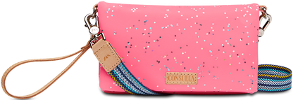 Neon pink crossbody purse with star confetti, tan leather tag, striped strap, "CONSUE" patch. Sizes: Small, Medium.