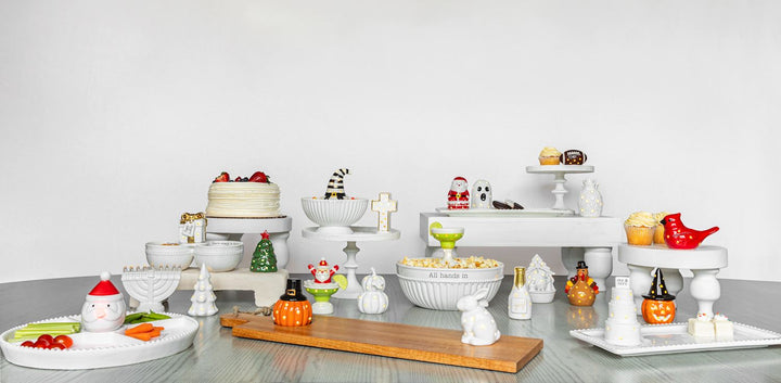 Holiday-themed ceramic serving dishes, Light-Up Nativity Sitter, and LED Christmas décor.