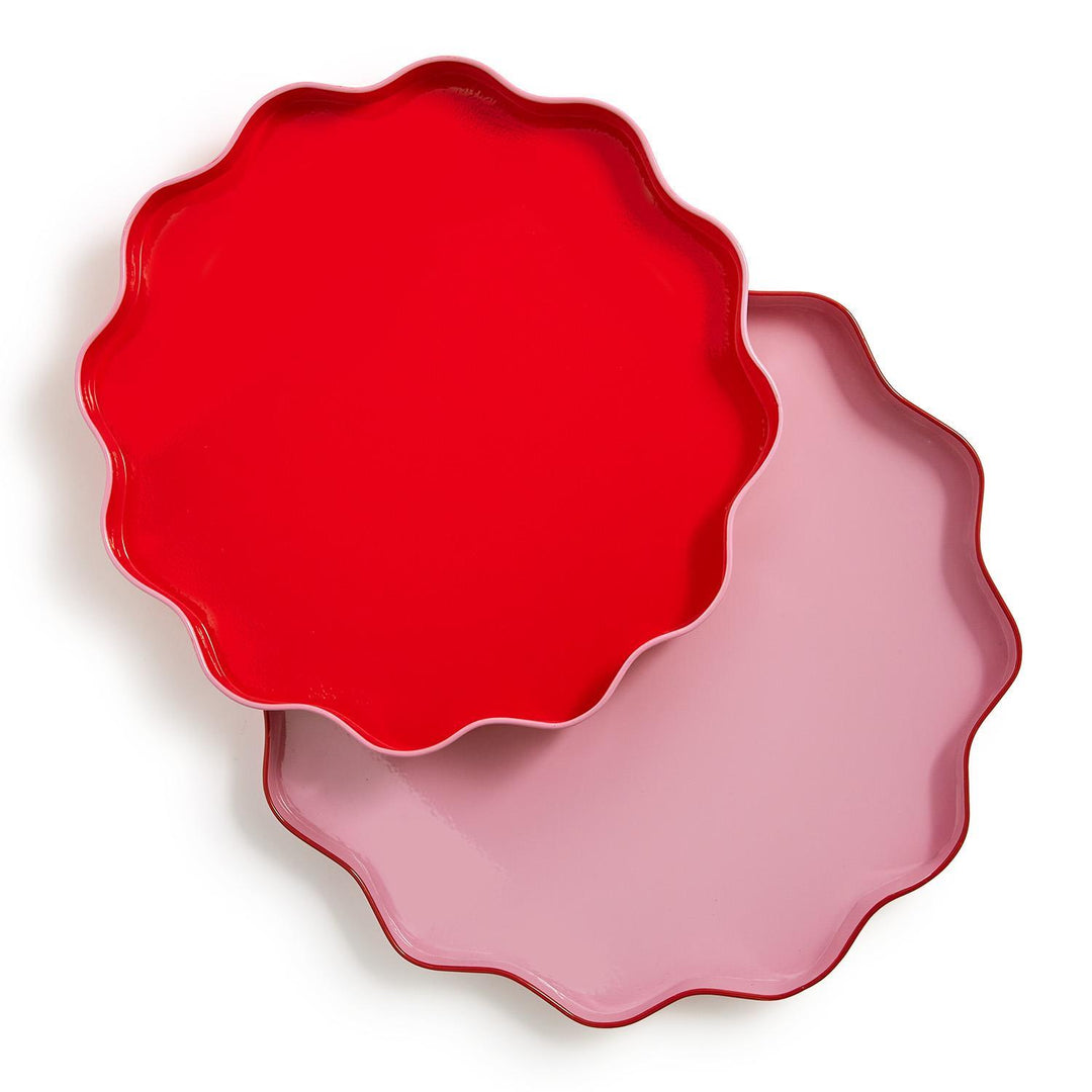 Bright red and light pink round scalloped decorative serving trays.