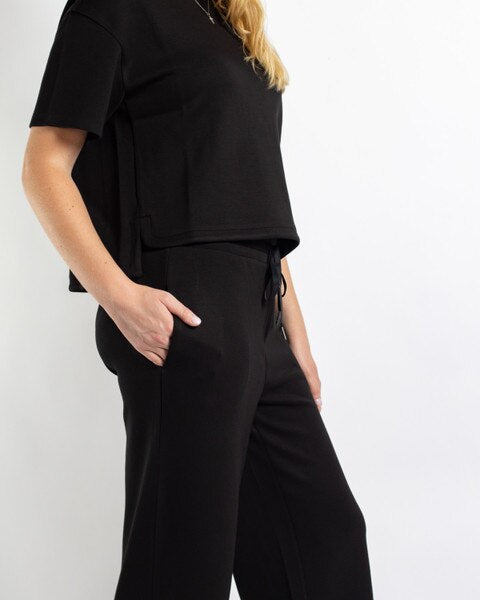 Taylor Pants: black high-waisted, relaxed fit pants with a drawstring waistband and side pockets.