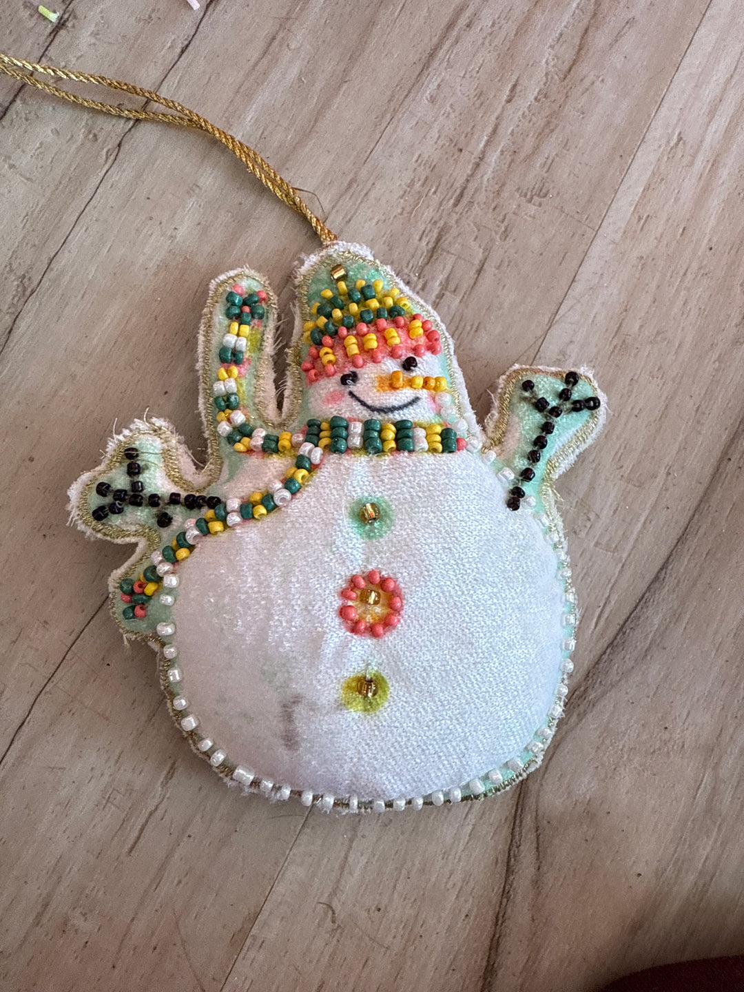 Cotton Velvet Snowman Ornament with embroidery, glass beads, and a gold hanging string.