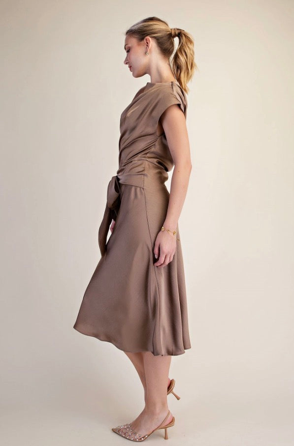 Asymmetrical Tie Midi Dress in taupe with short sleeves and an asymmetrical waist-tie; available in sizes XS–L.