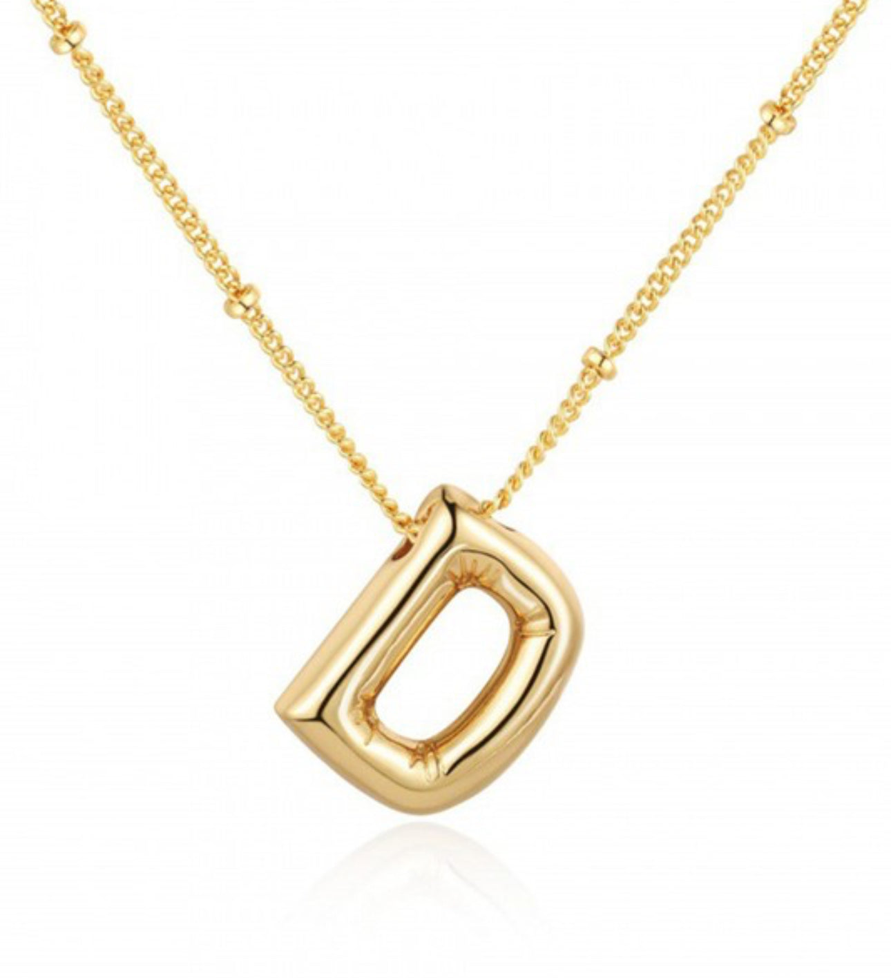 This Personalized Bubble Balloon Initial Necklace features an abstract letter "d" pendant. It is suspended on a bead chain necklace.