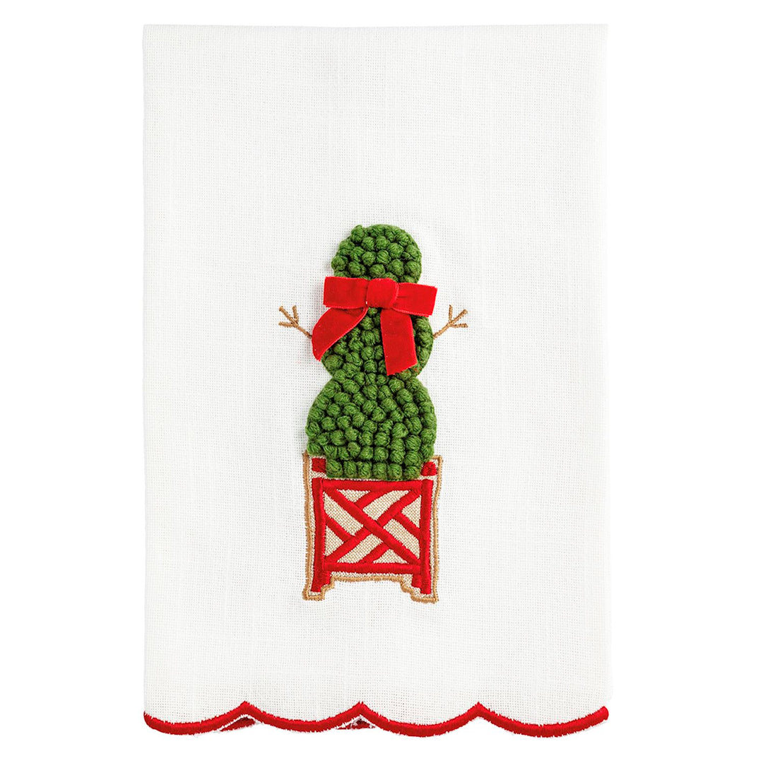 White Christmas topiary hand towel with scalloped red edge, featuring an embroidered green topiary in a red lattice planter with a red ribbon.