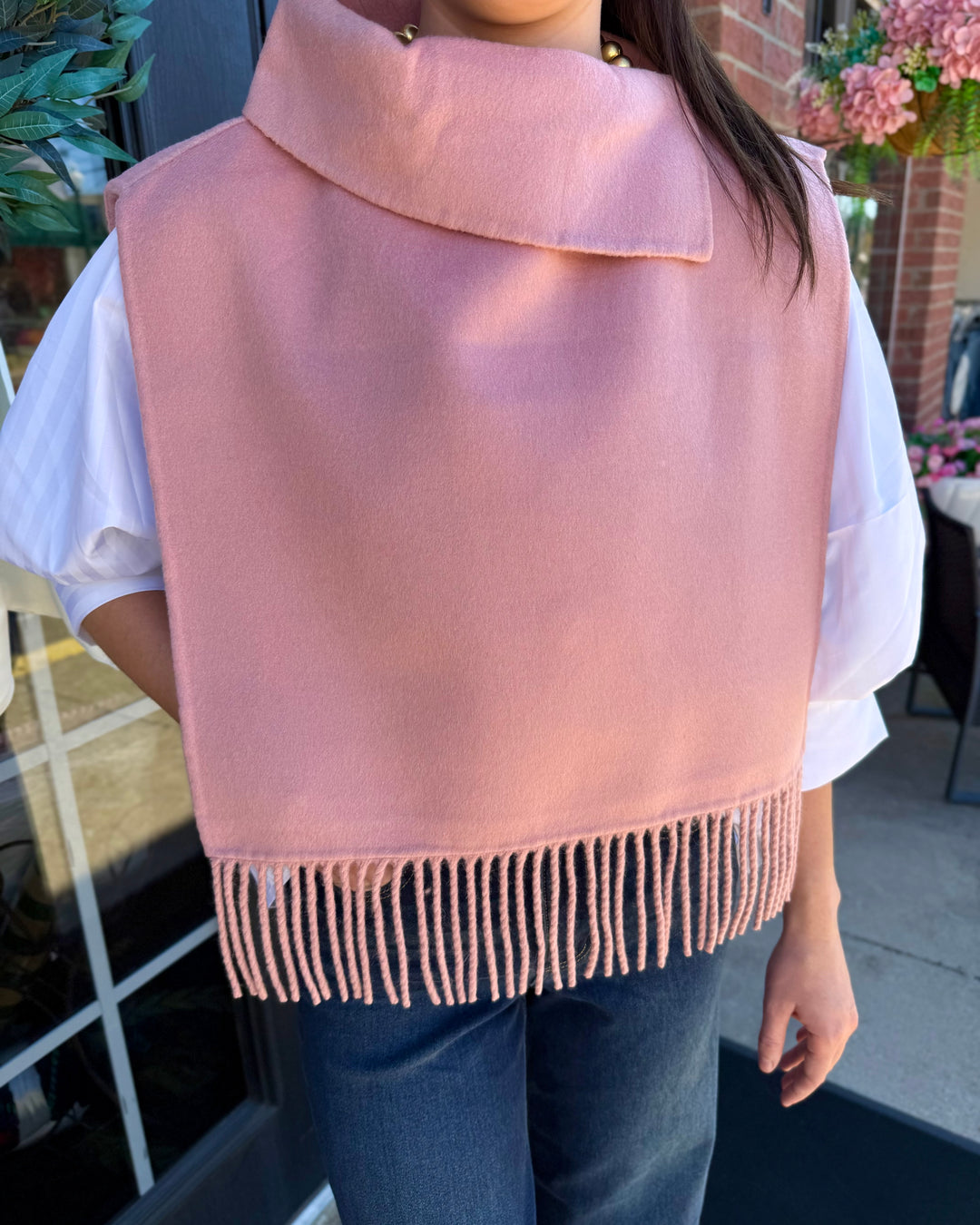 Blush pink collar poncho with fringe and wide collar.