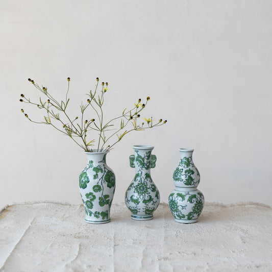 Hand painted green and white stoneware vases with floral designs. Available in small, medium, and large sizes.