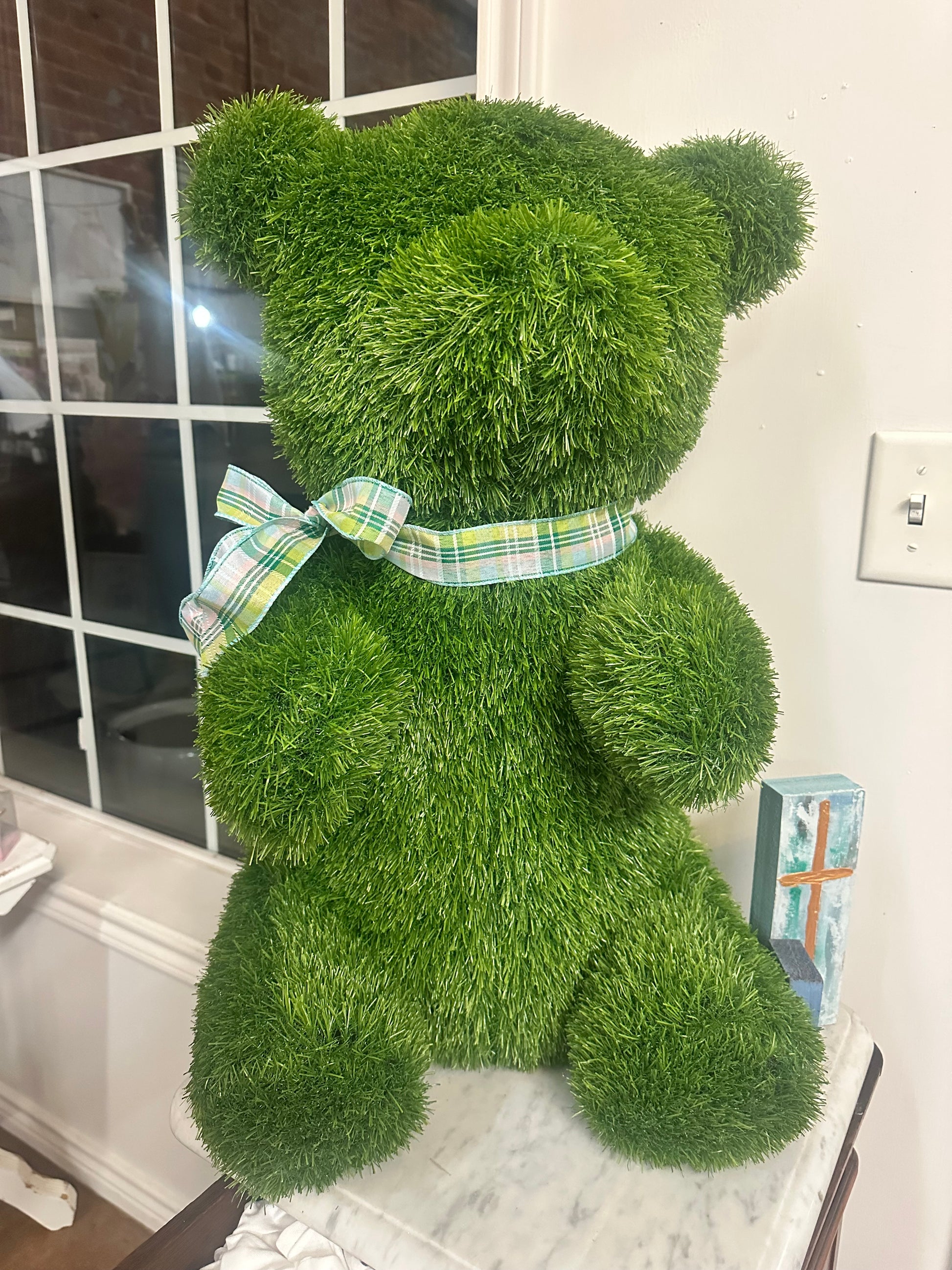 Grass Teddy Bear with green artificial grass and plaid ribbon. Available in small, medium, and large sizes.