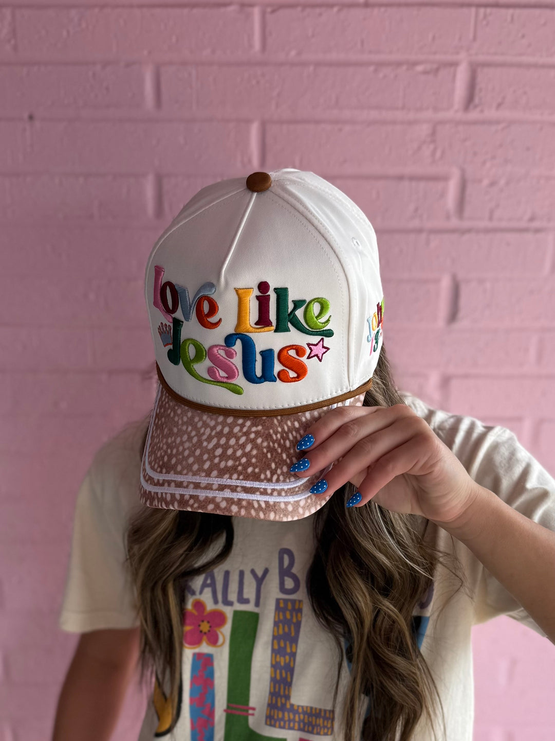White embroidered "Love Like Jesus" hat. Available in S, M, L.