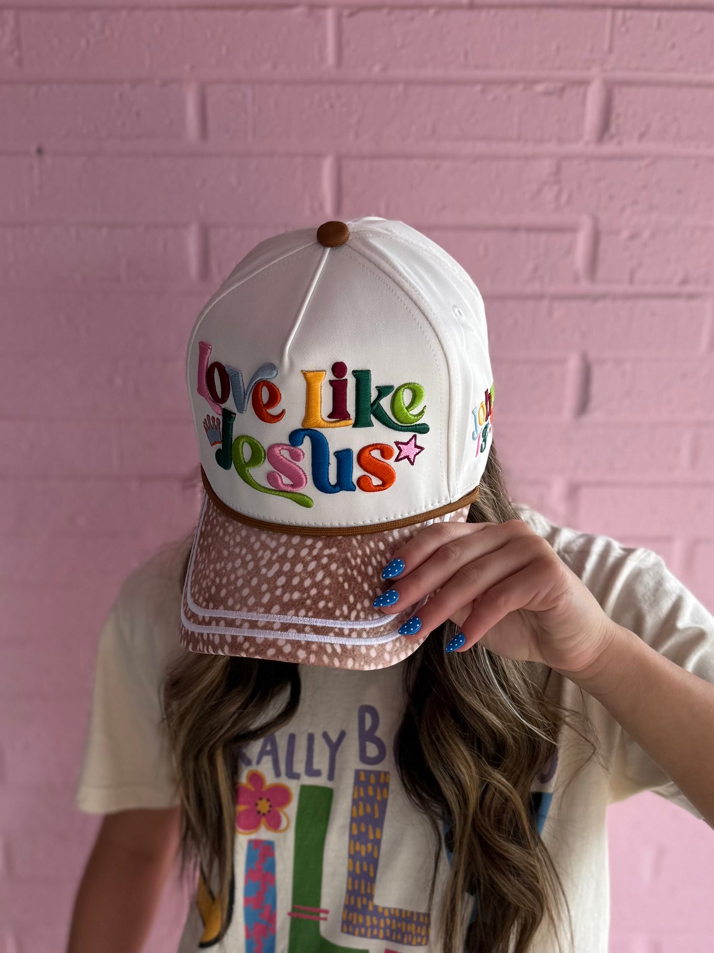 White embroidered "Love Like Jesus" hat. Available in S, M, L.