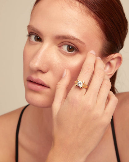 Gold Ring with White Cubic Zirconia—handcrafted, gold-plated, featuring a large clear cubic zirconia stone and detailed gold accents. Available in sizes 5–9.