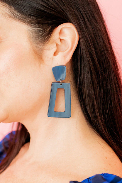 Kennedy Earrings: Bold statement piece in vibrant blue, featuring a stainless steel triangle and open trapezoid design. Available sizes: Standard.