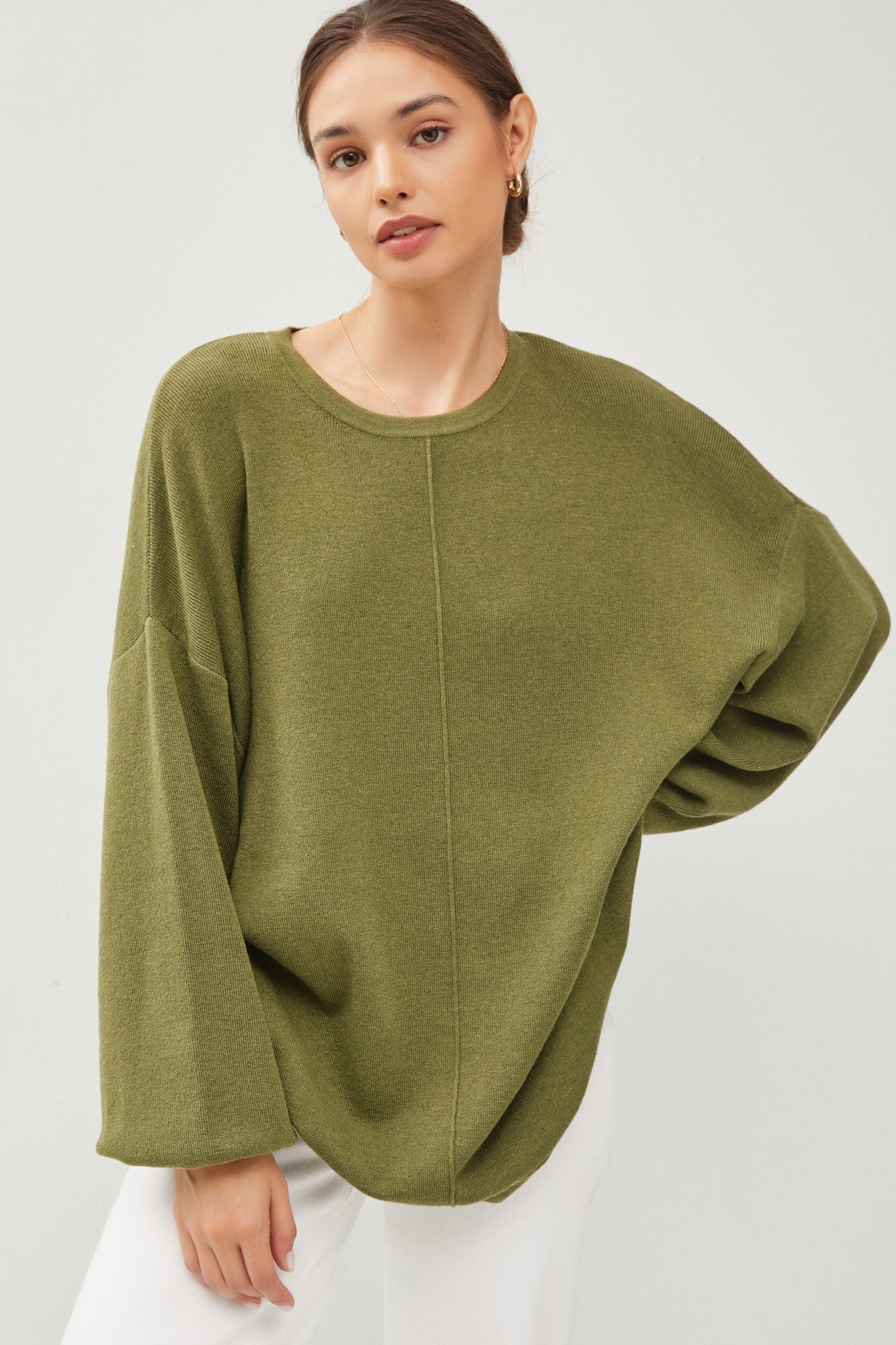 This product, The Augusta Sweater, is a unique piece that features wide sleeves and a visible seam down the front, making it both stylish and comfortable. It's a versatile item that can be dressed up or down for any occasion. This sweater is available in a range of sizes to fit various body types. The available sizes are small, medium, large, and extra-large.