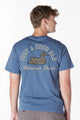 Blue mineral washed tee with dog illustration, "Just a good day," and "Mountain Khakis" text on back. Sizes S-XXL.