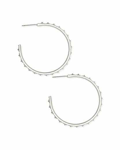 Large silver hoop earrings with iridescent crystals and textured spiked edges. Available in one size.
