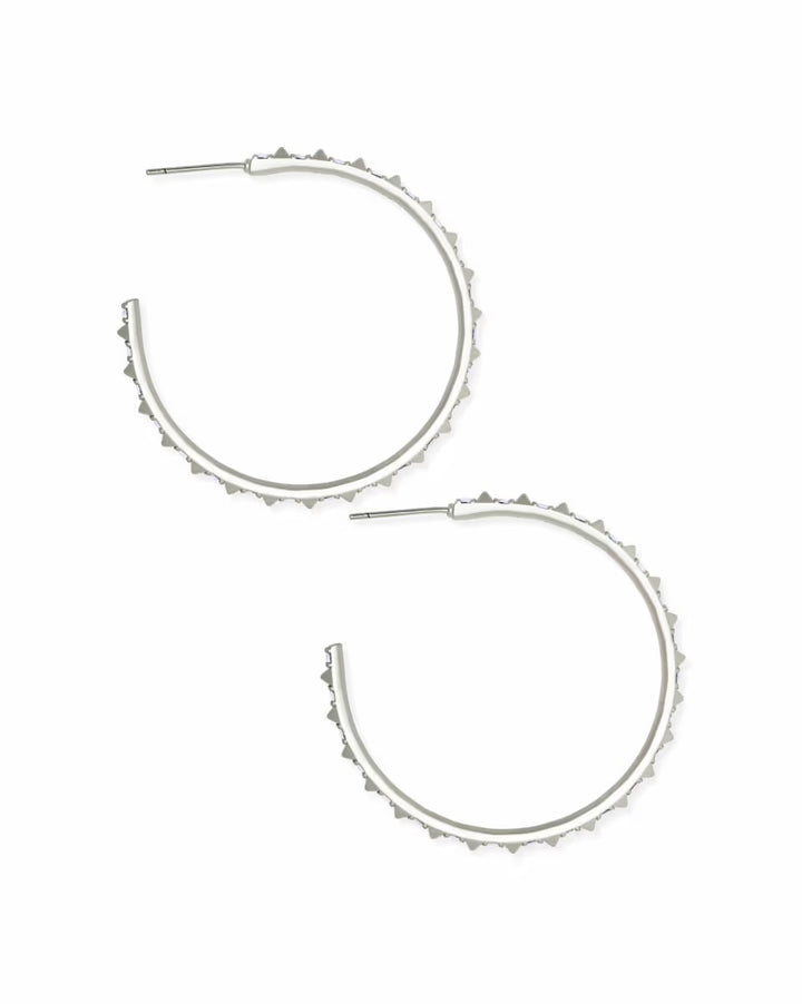 Large silver hoop earrings with iridescent crystals and textured spiked edges. Available in one size.