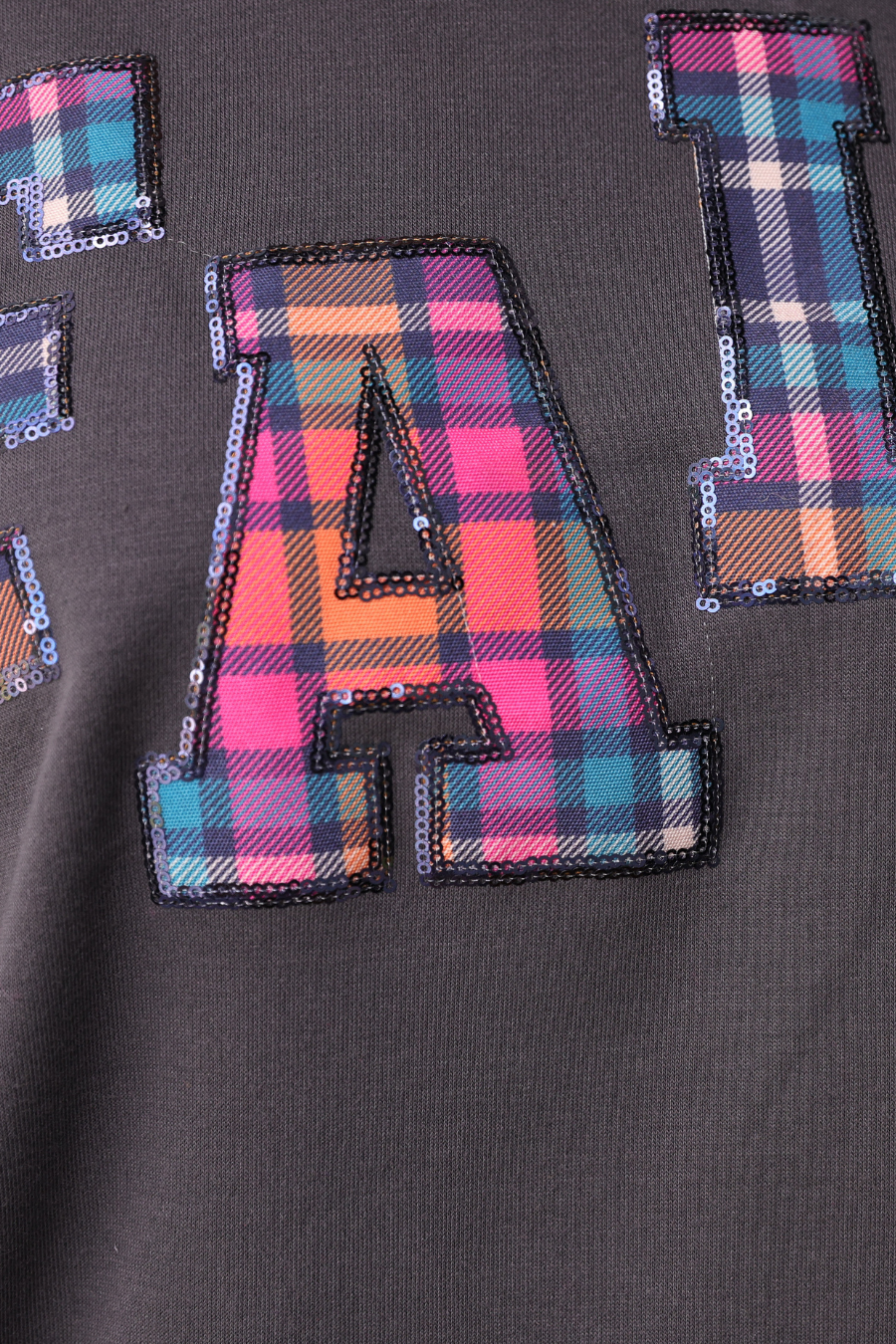 Fall Plaid Patch Pullover with dark fabric, large plaid letter “A” accented with sequins. Available in sizes S–XL.