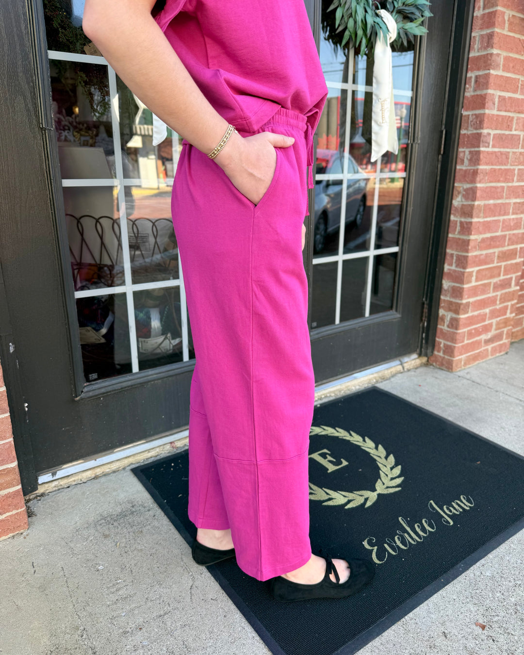 Fuchsia barrel-leg knit pants with drawstring waistband and side pockets. Available in various sizes.