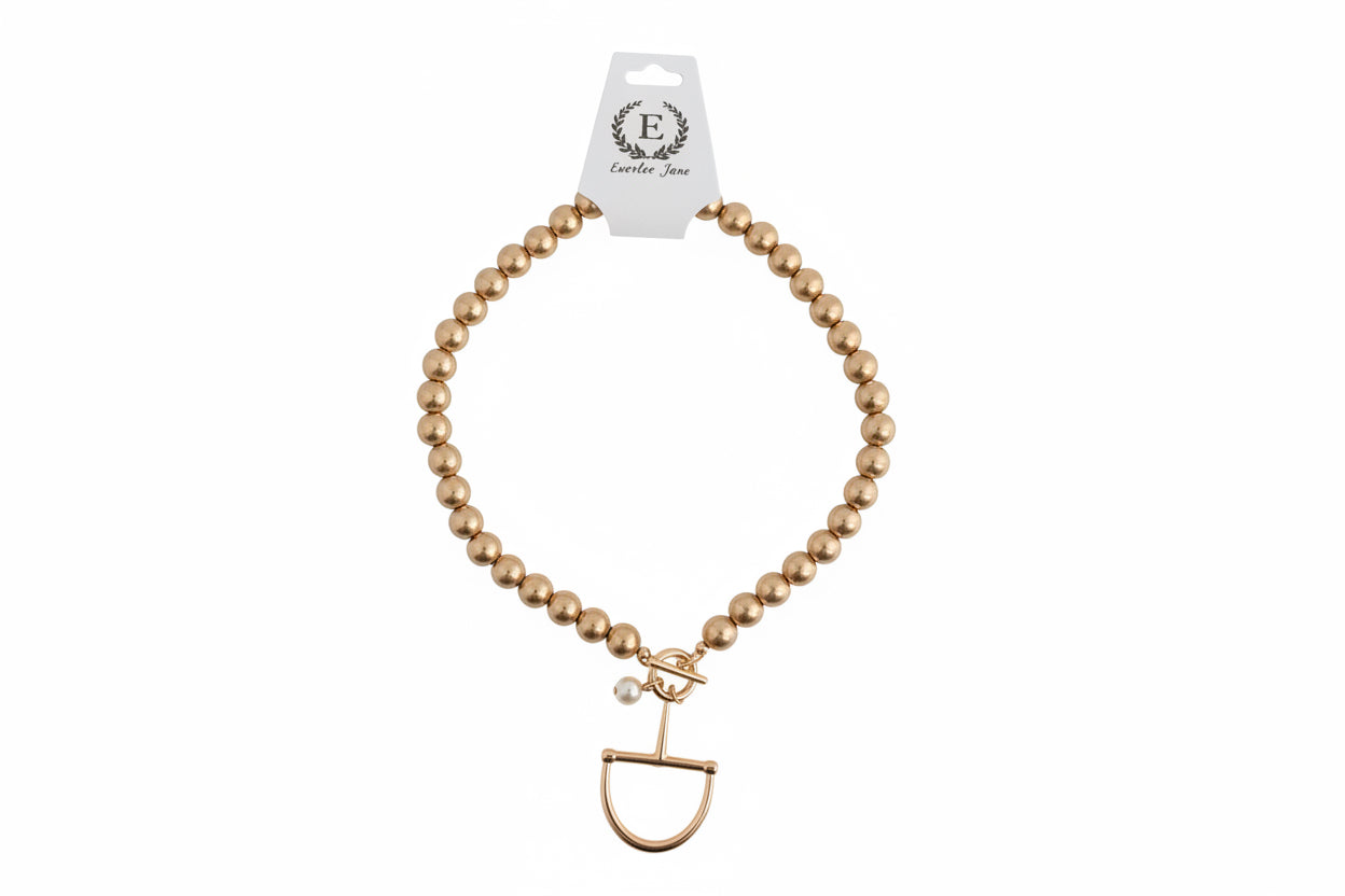 Gold Beaded Horse Bit Necklace with toggle clasp and small pearl charm. Sizes available: 16″, 18″.