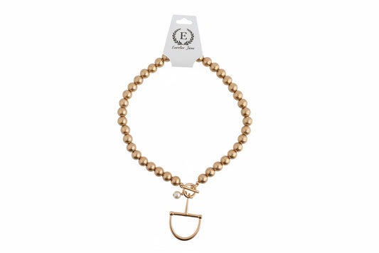 Gold Beaded Horse Bit Necklace with toggle clasp and small pearl charm. Sizes available: 16″, 18″.