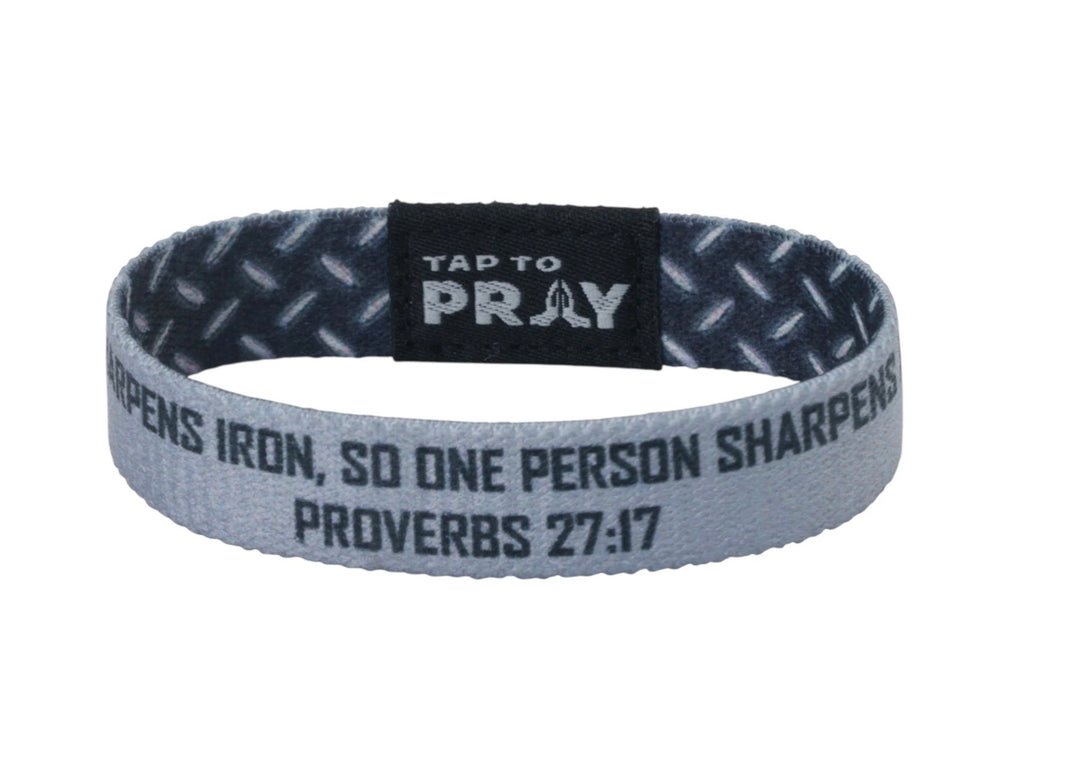 Gray fabric Tap To Pray™ Wristbands - Iron featuring a diamond plate pattern and the text “As iron sharpens iron, so one person sharpens another. Proverbs 27:17.”
