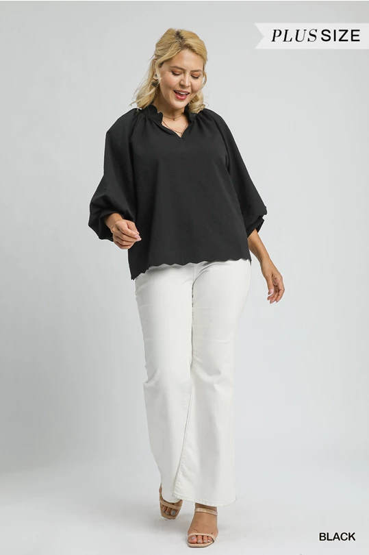 Plus size black textured scalloped hem blouse. Available in sizes 1X-4X. Labeled "BLACK.