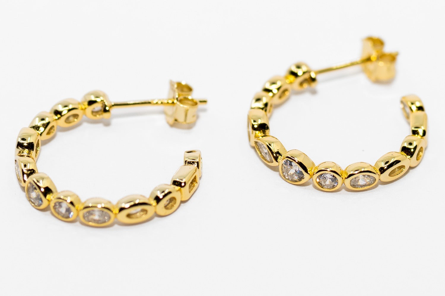 Tango Gold Earrings in 18K gold with round clear gemstones set on front. Available sizes: small, medium, large.