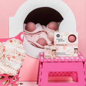 Dryer Ball Kits Sweet Grace inside a pink dryer; kit available in standard and large sizes.