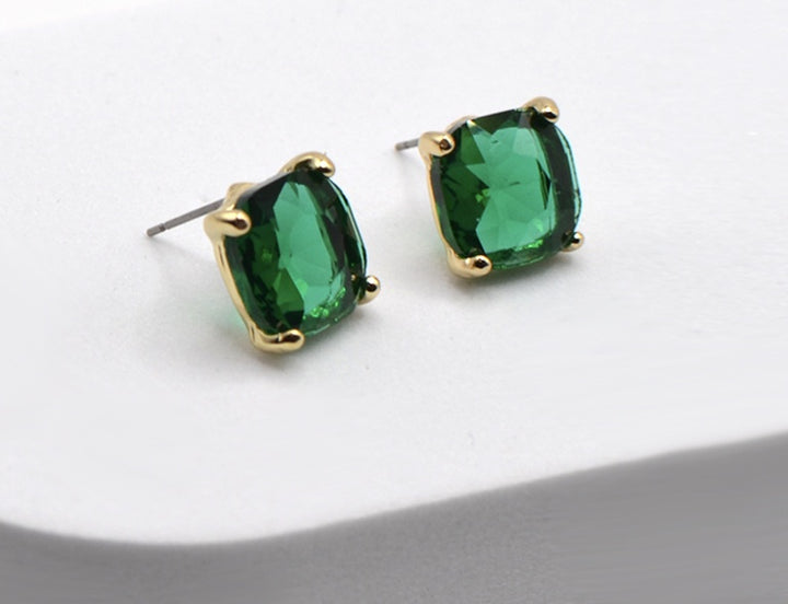 The Uma Earrings by Meghan Browne: square green crystals in gold-tone bezels. Sizes available: small, medium.