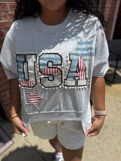 USA Patch Tee: 100% cotton, gray, stars-and-stripes applique in red, white, blue. Available in S-XL.