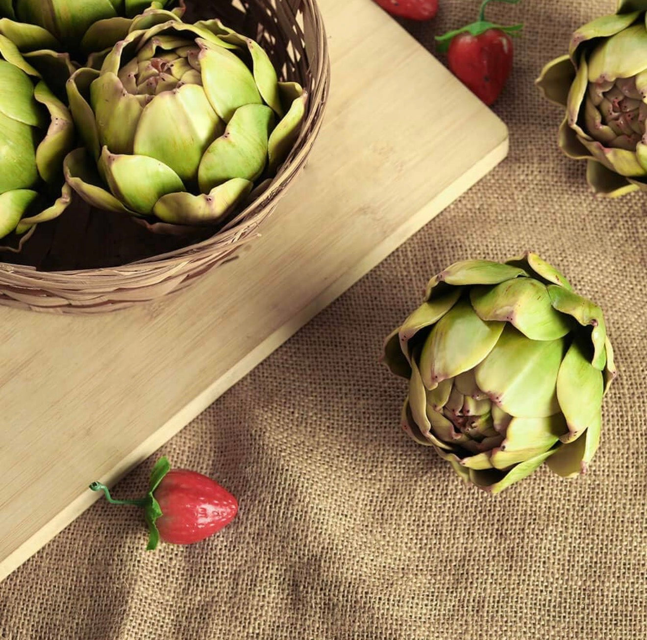 Faux Artichoke Decor available in small, medium, and large sizes; displayed in a basket and on a wooden board.