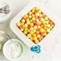 Square white dish of colorful melon balls. The Sunning &amp; Funning Minis. Available in mini size only.