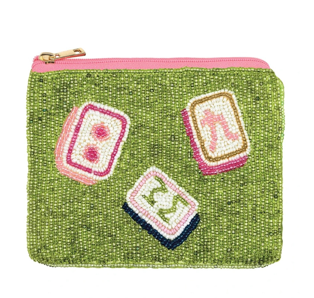 Green beaded pouch with three embroidered mahjong tiles and pink zipper.