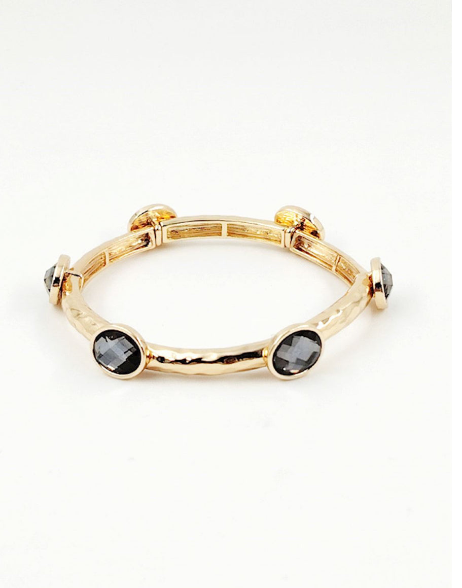 Gabby Black Diamond gold stretch bangle with four black faceted stones in bezel settings. Available sizes: S, M, L.