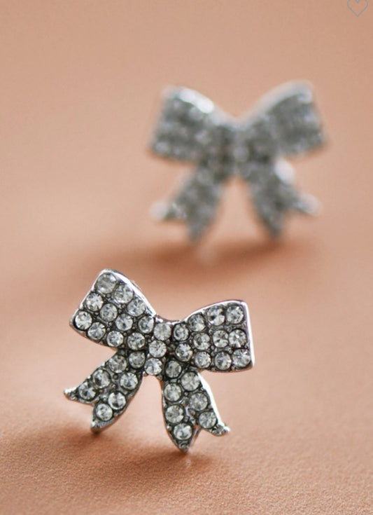 These Pave Rhinestone Bow Stud Earrings are beautifully adorned with sparkling stones. Offered as a pair, these stud earrings feature a charming bow design that's dazzlingly accentuated by pave rhinestones. Available in one standard size.