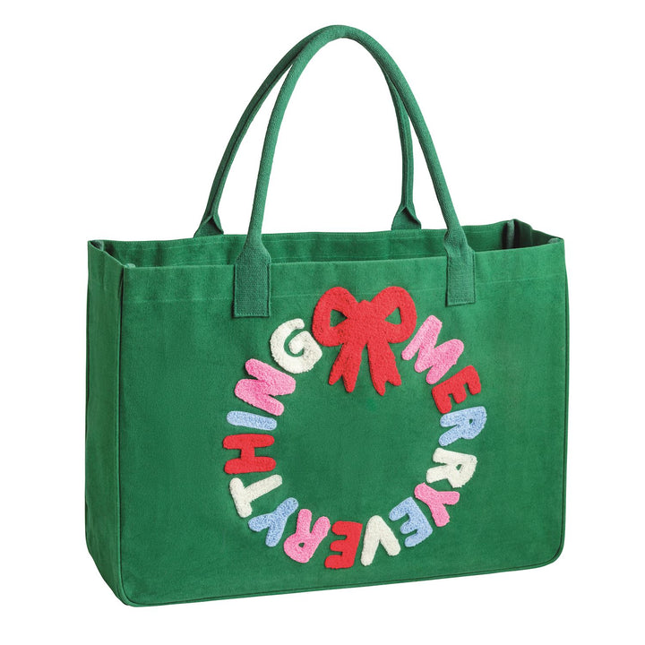 Holiday Boucle Tote: green canvas bag with cotton webbing handles, featuring a “MERRY EVERYTHING” wreath appliqué and red bow.