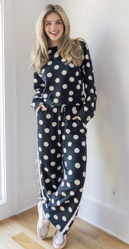 Harper Polka Dot Quarter Zip lounge set with large white polka dots and wide-leg pants. Available in sizes XS–XL.