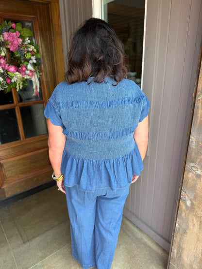 Blaire Chambray Smocked Peplum Top with scalloped ruffle sleeves, available in sizes XS–XL.